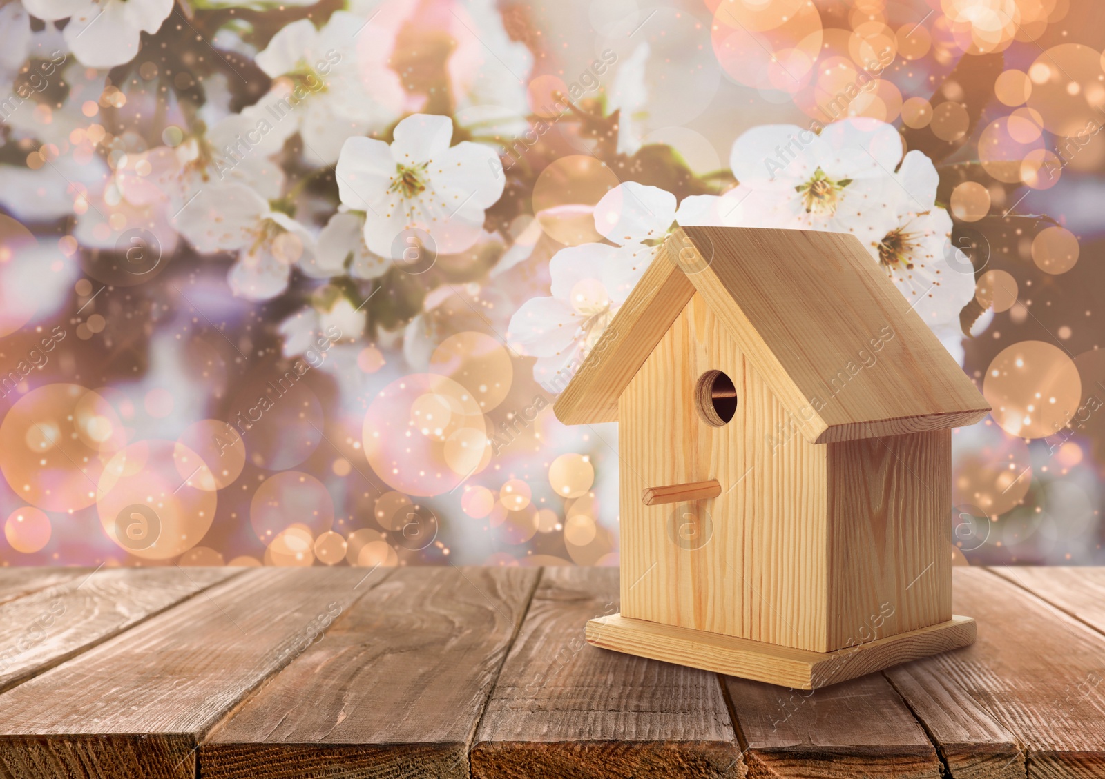 Image of Beautiful bird house on wooden table outdoors, space for text