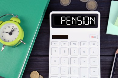 Image of Calculator with word Pension, coins, alarm clock and stationery on dark wooden table, flat lay