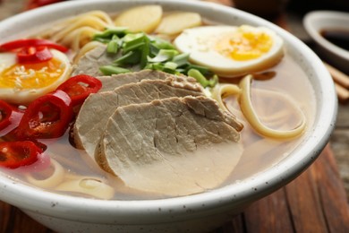 Delicious ramen in bowl on table, closeup. Noodle soup