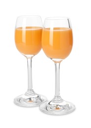 Tasty tangerine liqueur in glasses isolated on white