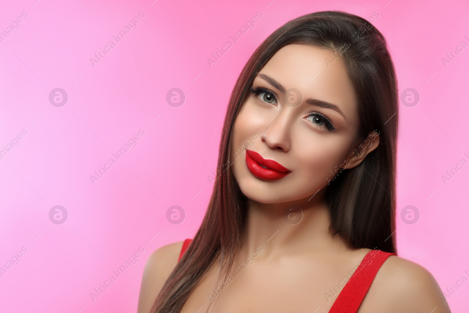 Photo of Beautiful woman with red lipstick on pink background, space for text