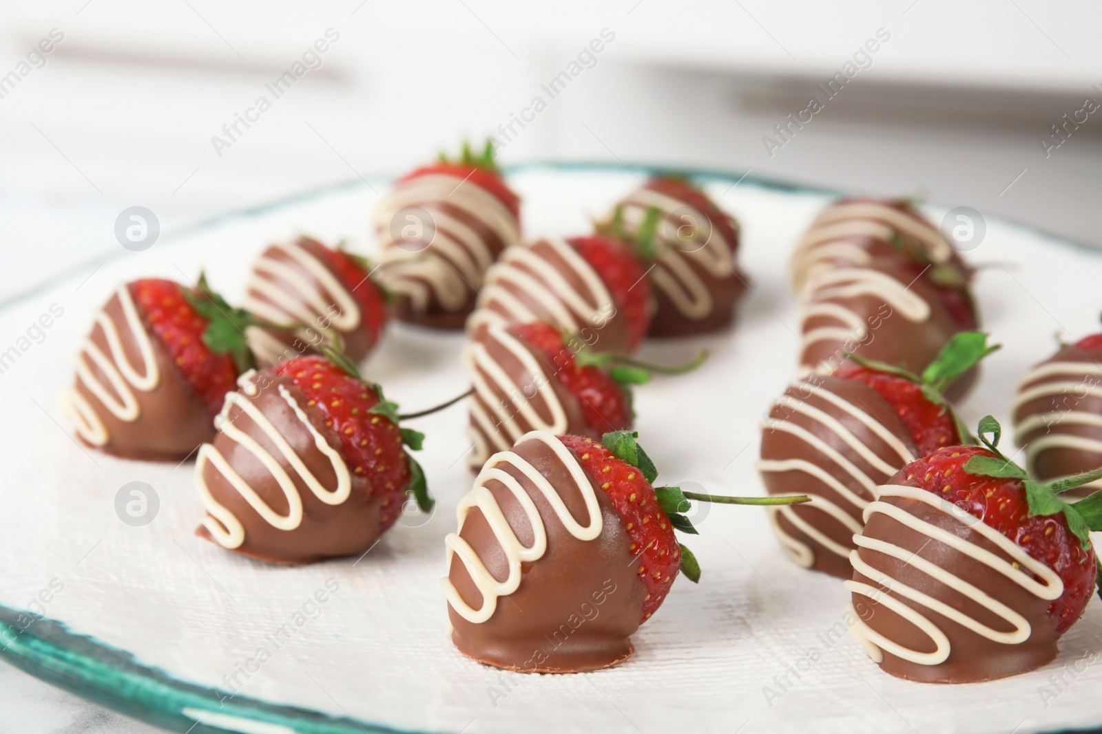 Photo of Tasty chocolate dipped strawberries on plate, closeup