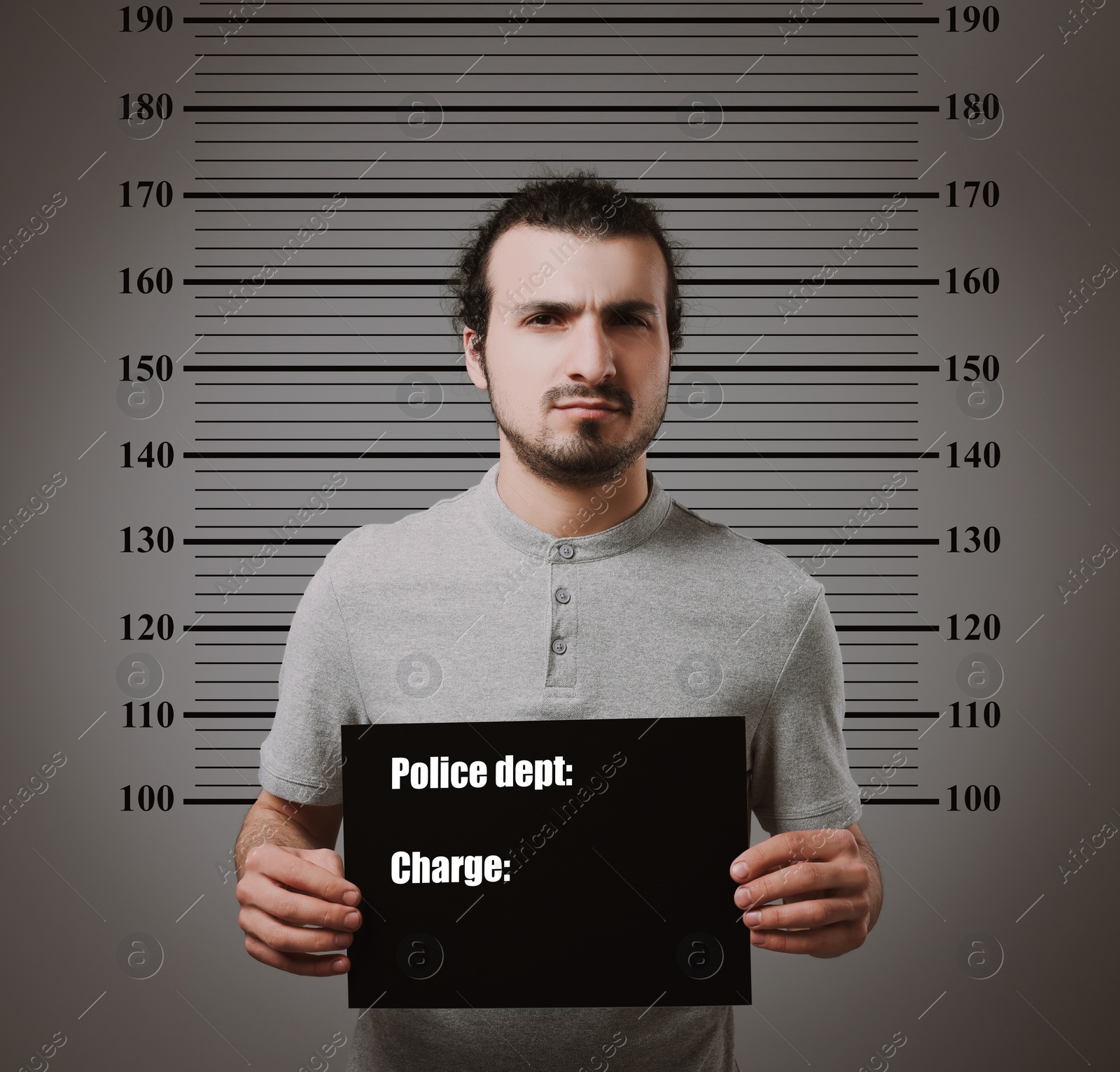 Image of Criminal mugshot. Arrested man with blank card against height chart