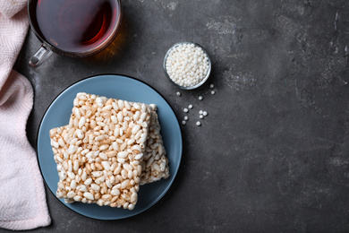 Photo of Delicious rice crispy treats on grey table, flat lay. Space for text