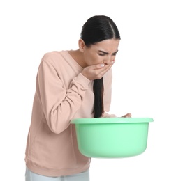 Photo of Woman with basin suffering from nausea on white background. Food poisoning