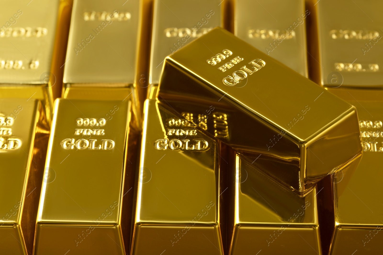 Photo of Many shiny gold bars as background, closeup