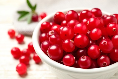 Photo of Tasty ripe cranberries on white table, closeup