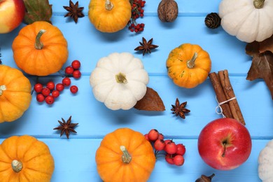 Thanksgiving day. Flat lay composition with pumpkins on light blue wooden table