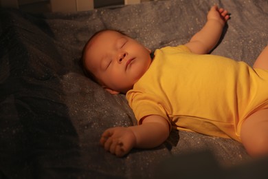 Photo of Cute newborn baby sleeping in crib at night