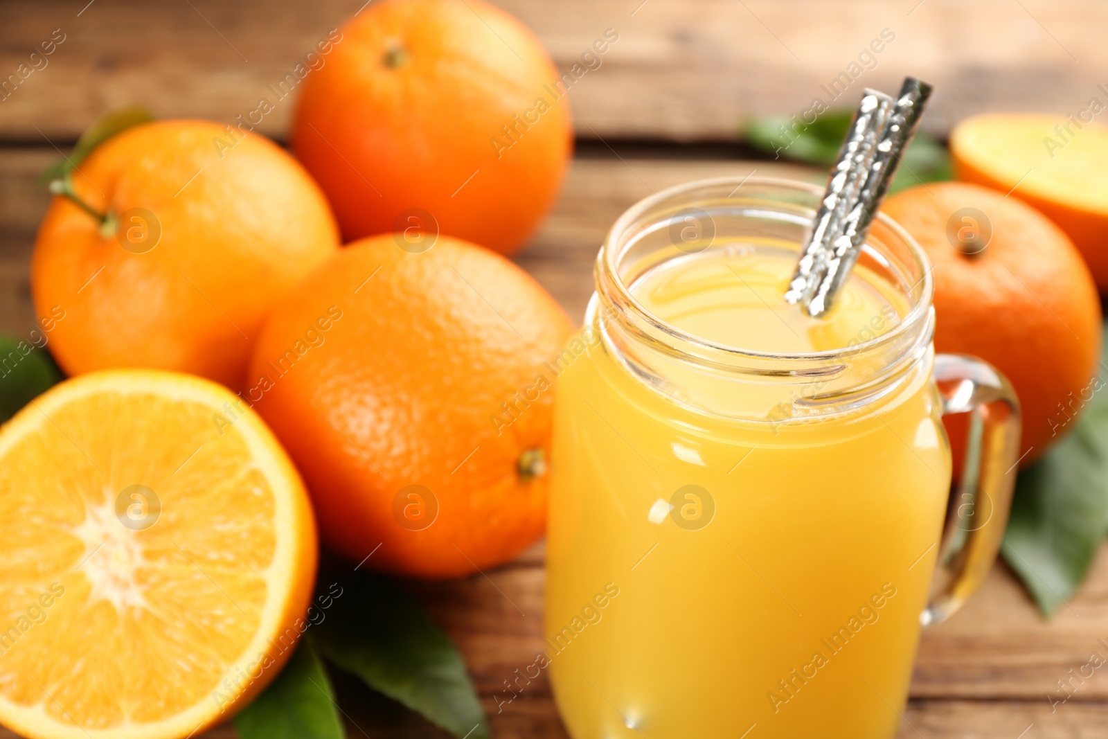 Photo of Delicious orange juice and fresh fruits on table, closeup