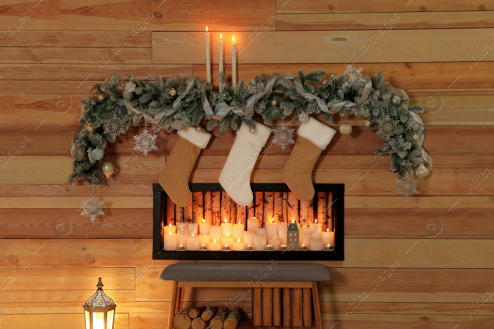 Photo of Festive room interior with decorative fireplace and Christmas stockings