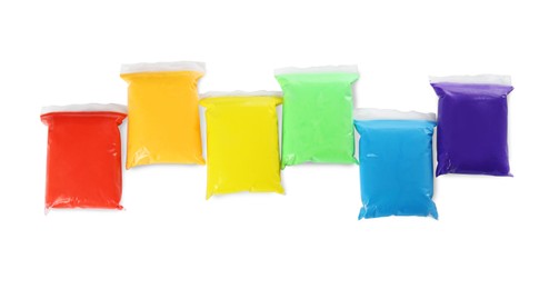 Packages of colorful play dough on white background, top view