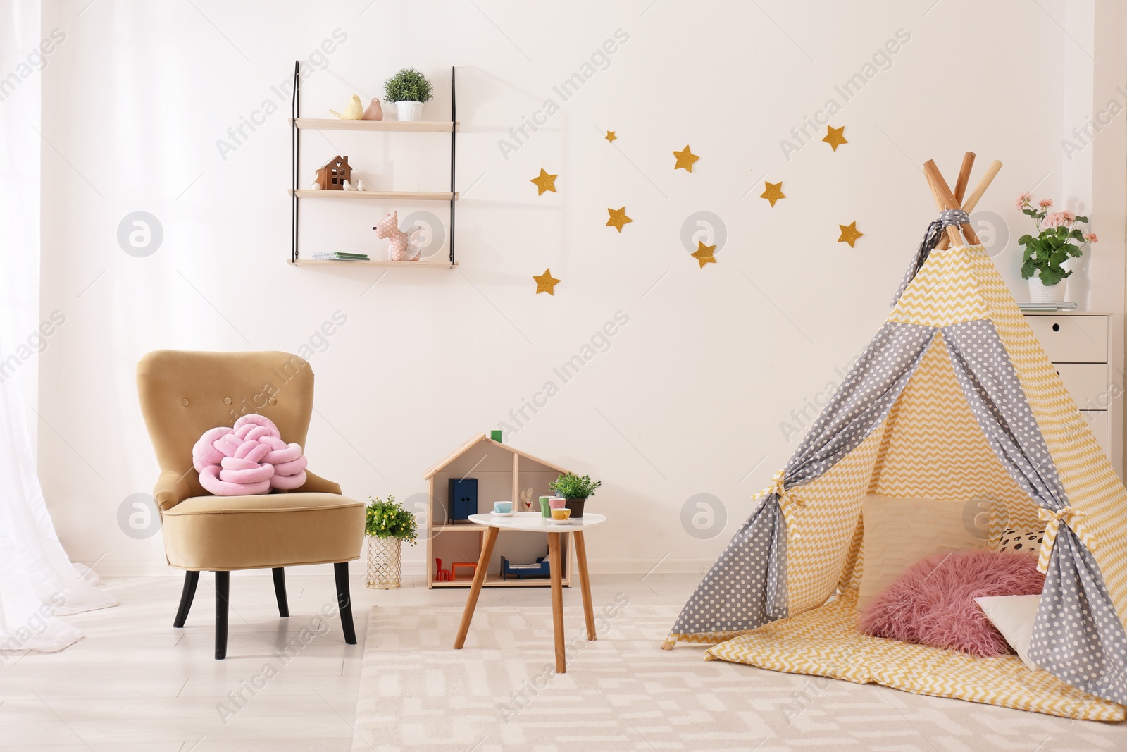 Photo of Cozy kids room interior with play tent and toys