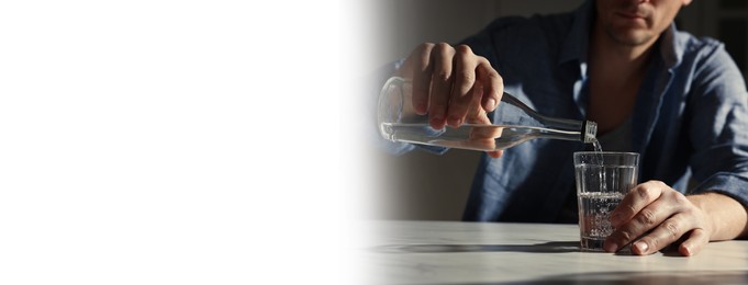 Image of Suffering from hangover. Man pouring alcoholic drink into glass at table indoors, closeup. Banner design with space for text