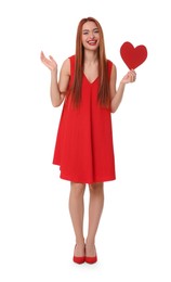 Young woman in red dress with paper heart on white background