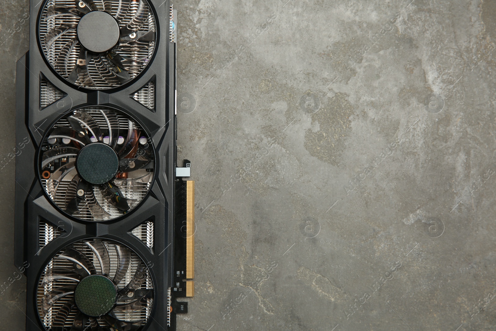 Photo of One graphics card on grey table, top view. Space for text