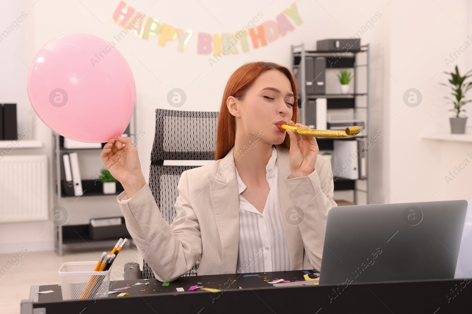 Photo of Young woman having fun during office party at workplace