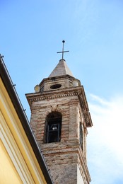 Photo of Beautiful church with tower against blue sky, low angle view