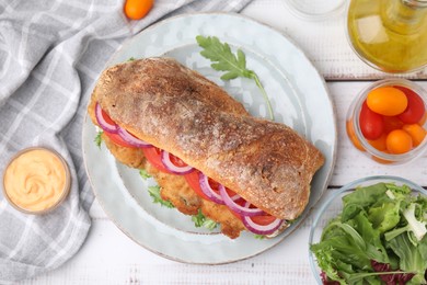 Photo of Delicious sandwich with schnitzel on white wooden table, flat lay