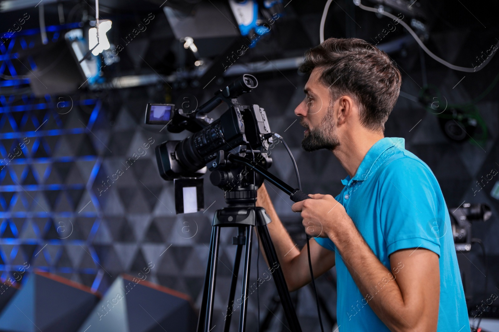 Photo of Professional video camera operator working in studio