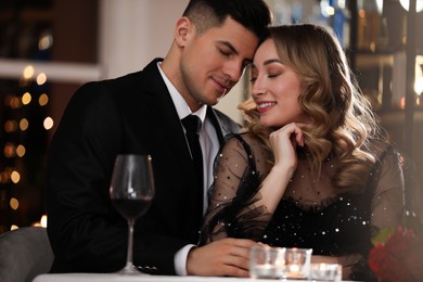 Photo of Lovely couple having romantic dinner on Valentine's day in restaurant