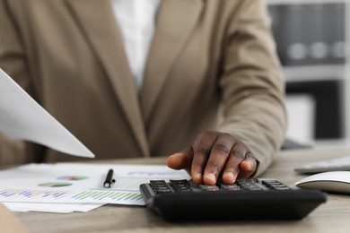 Professional accountant working at wooden desk in office, closeup