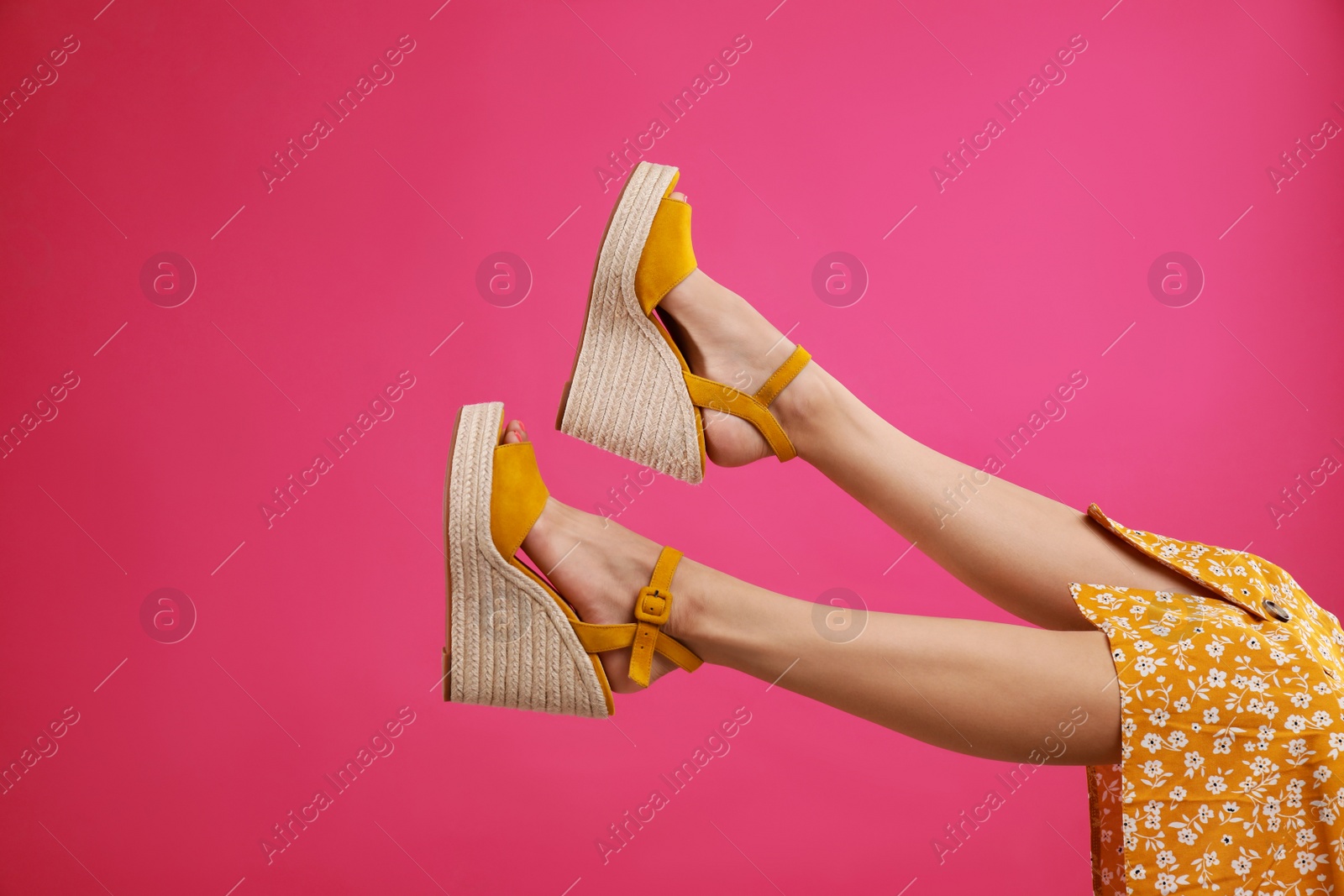 Photo of Woman in stylish shoes on pink background