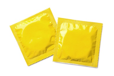 Yellow condom packages on white background, top view. Safe sex