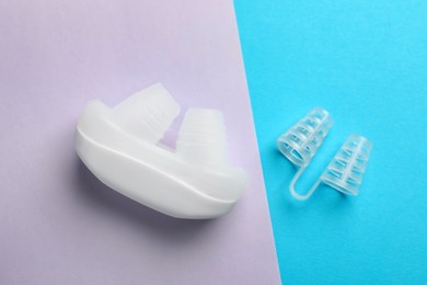 Photo of Different anti-snoring devices for nose on color background, flat lay