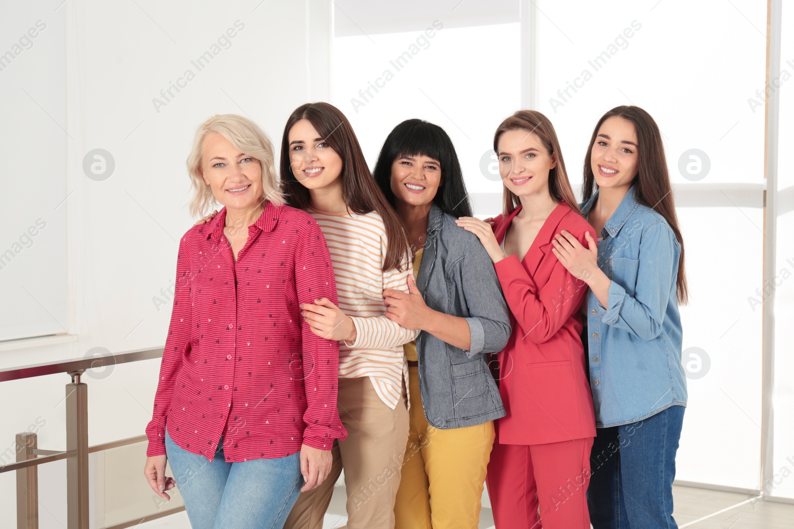 Photo of Group of ladies near window indoors. Women power concept