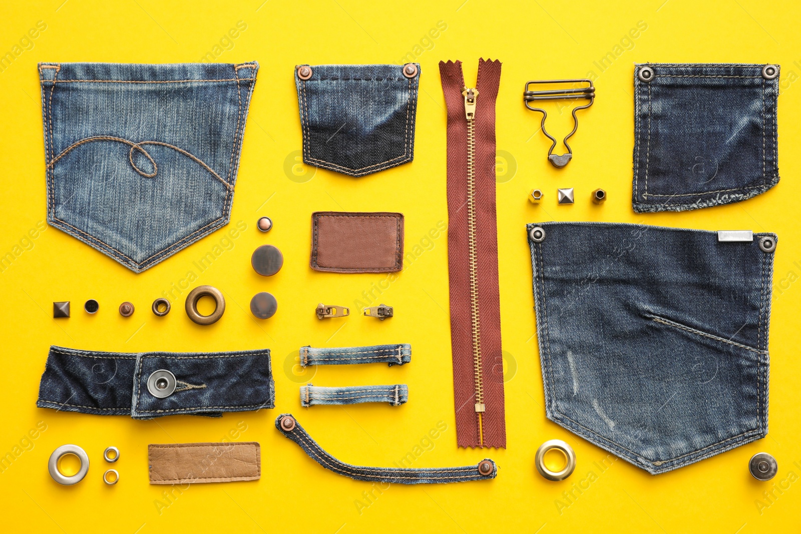 Photo of Flat lay composition with garment accessories and cutting details for jeans on yellow background