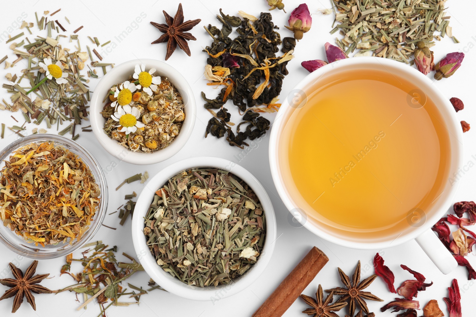 Photo of Composition with fresh brewed tea and dry leaves on white background, top view