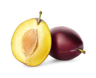 Whole and cut ripe plums on white background