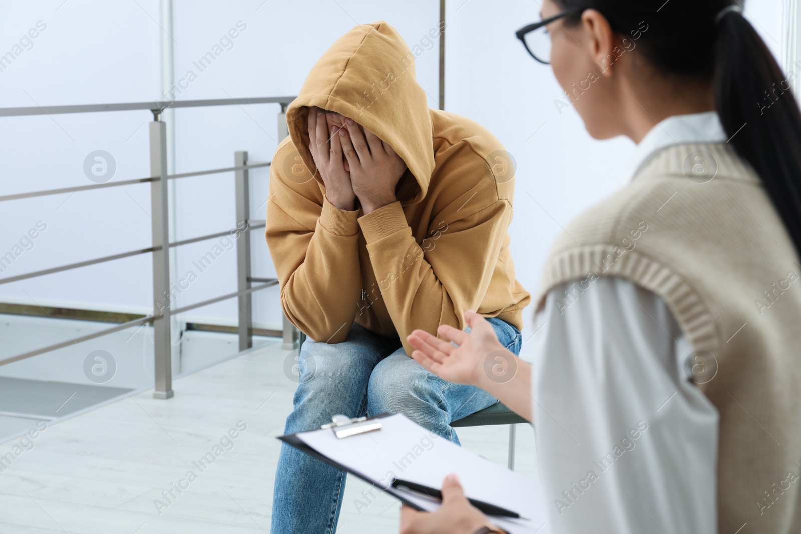 Photo of Psychotherapist working with drug addicted man indoors