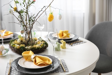 Beautiful Easter table setting with floral decor indoors