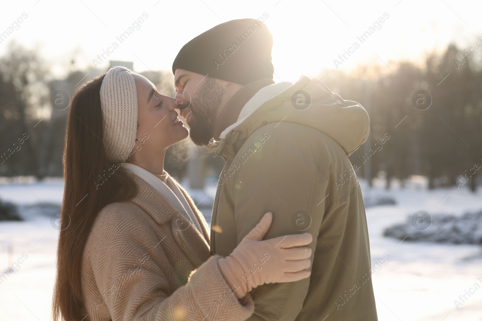 Photo of Beautiful happy couple in snowy park on winter day