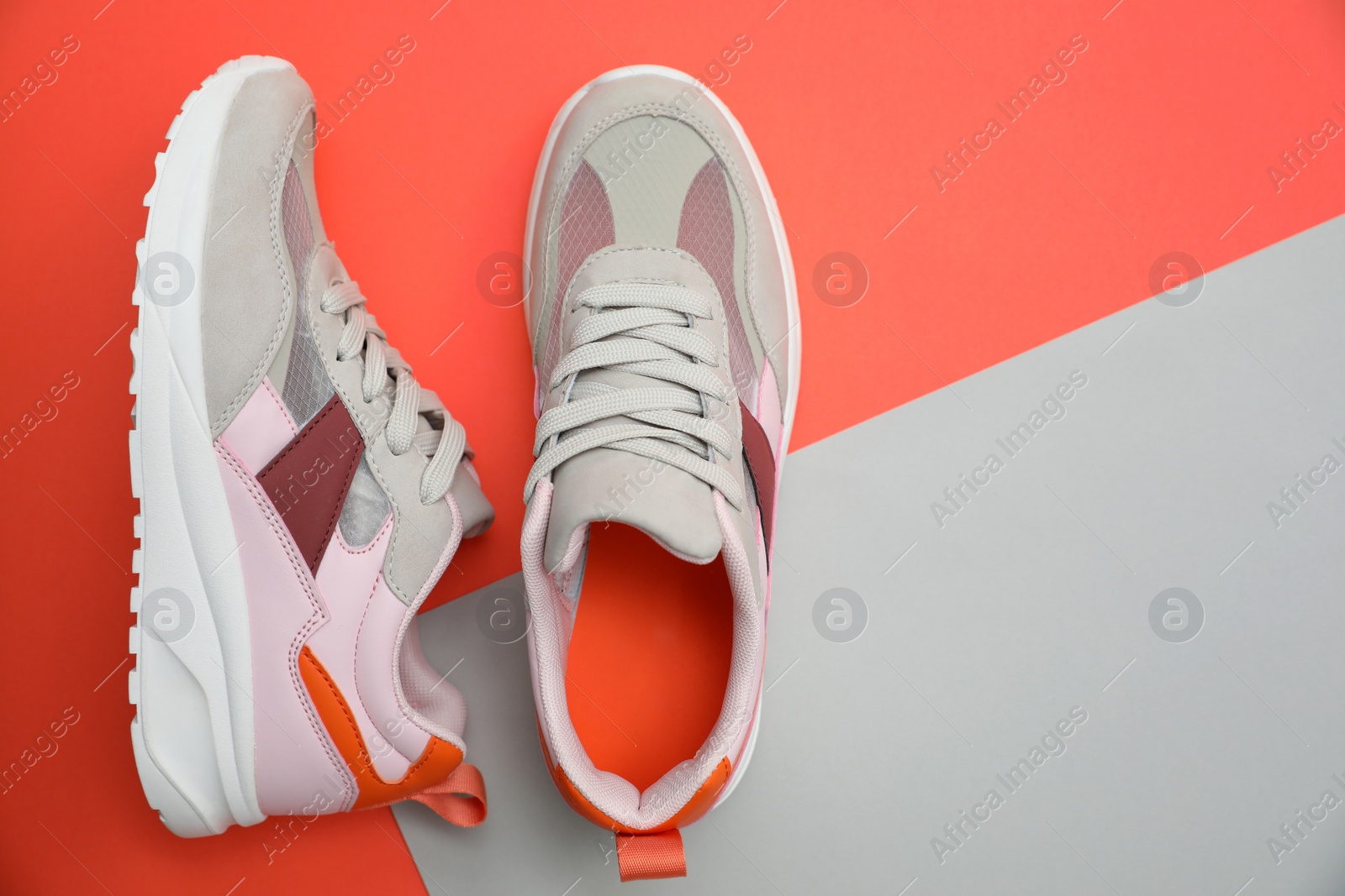 Photo of Stylish women's sneakers on color background, top view. Space for text