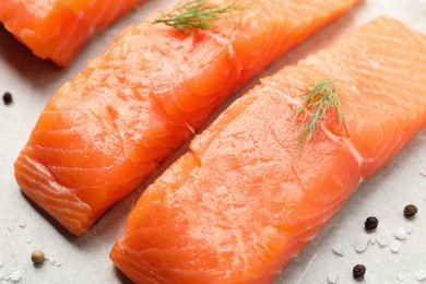Photo of Fresh raw salmon and ingredients for marinade on light grey table, closeup