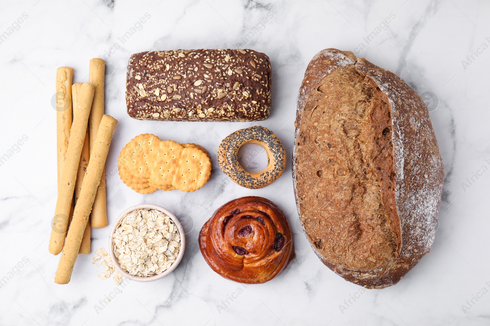 Photo of Different gluten free products on white marble table, flat lay