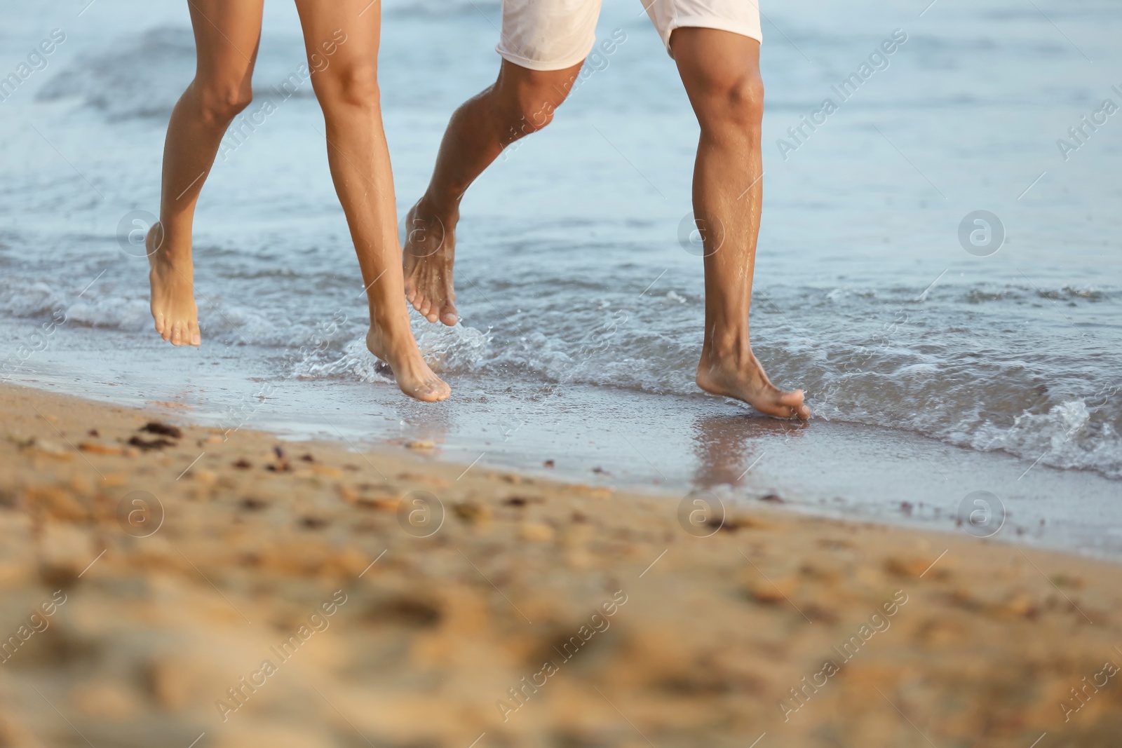 Photo of Happy young couple having fun at beach on sunny day