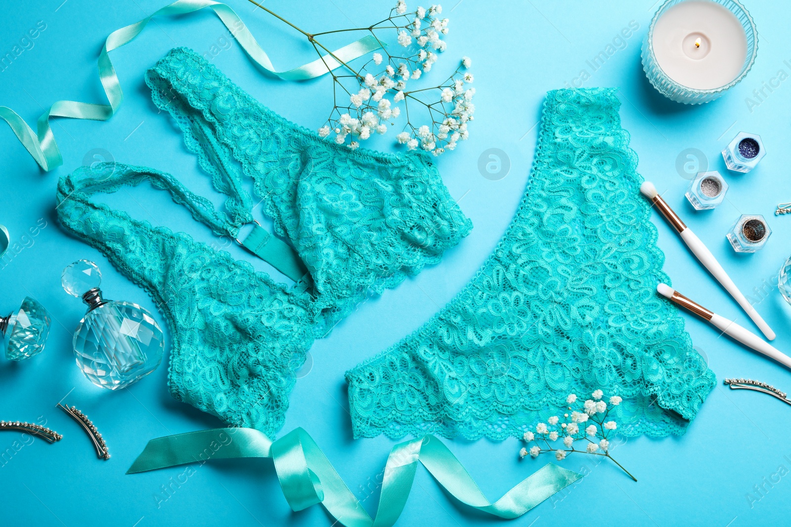 Photo of Flat lay composition with elegant women's underwear on light blue background