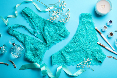 Photo of Flat lay composition with elegant women's underwear on light blue background