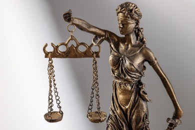 Symbol of fair treatment under law. Figure of Lady Justice on white background, closeup