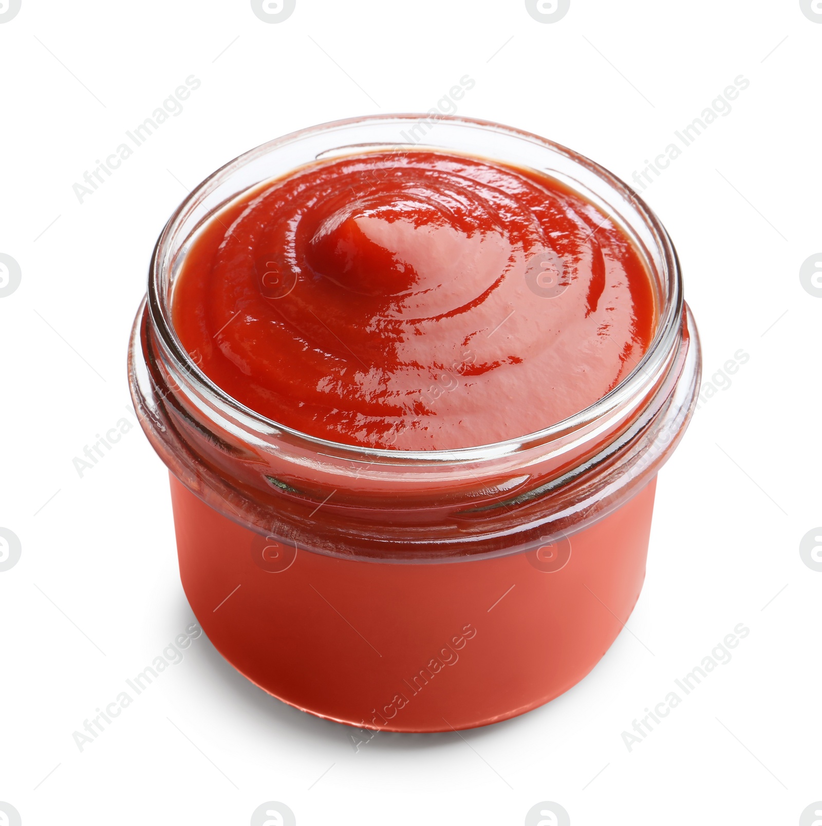 Photo of Tasty ketchup in glass jar isolated on white. Tomato sauce