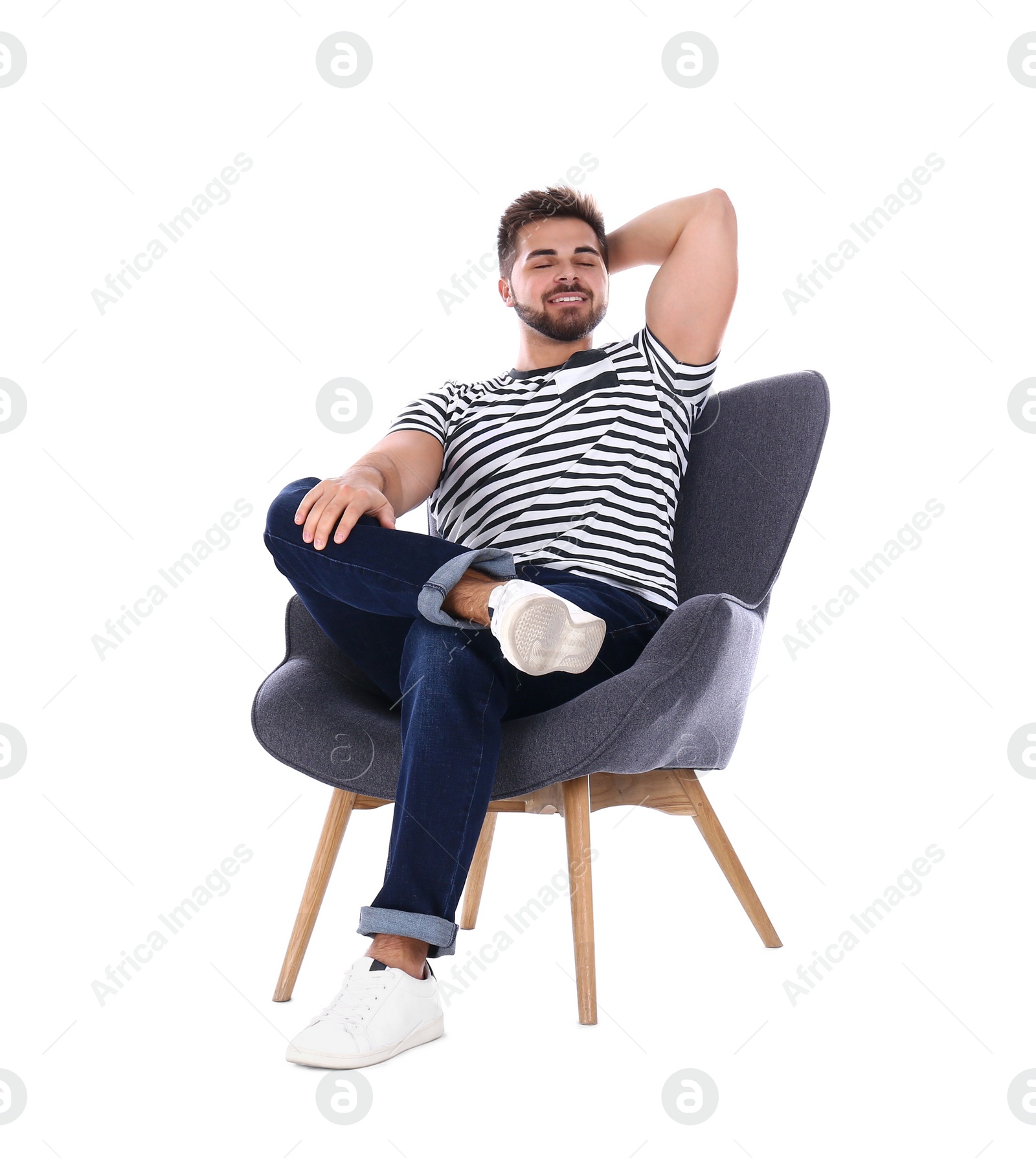 Photo of Young man sitting in armchair isolated on white