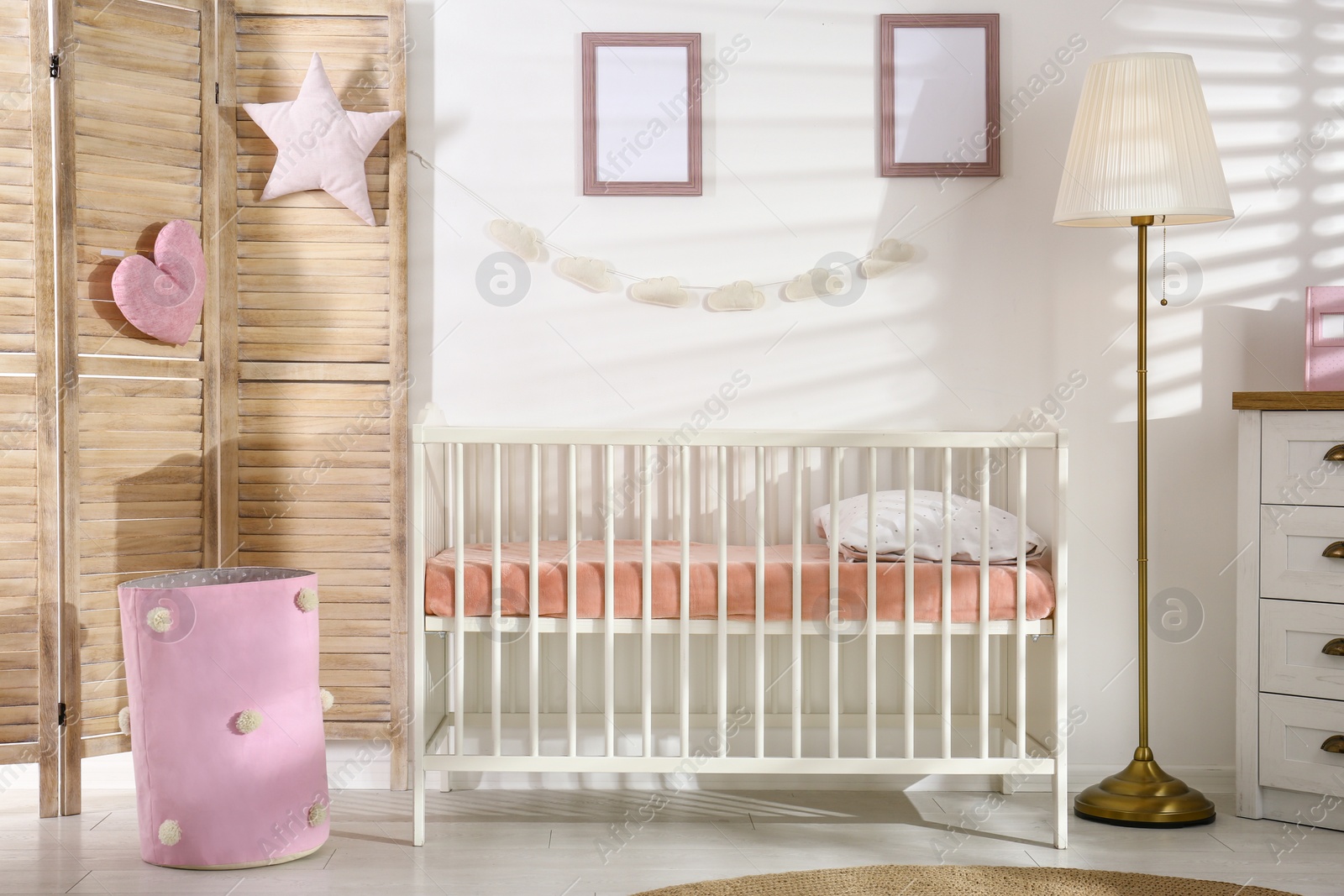 Photo of Cozy baby room interior with comfortable crib