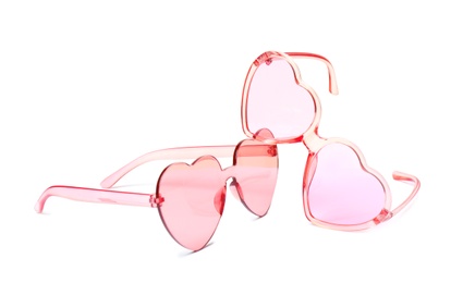 Different stylish heart shaped glasses on white background