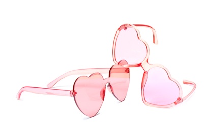 Photo of Different stylish heart shaped glasses on white background