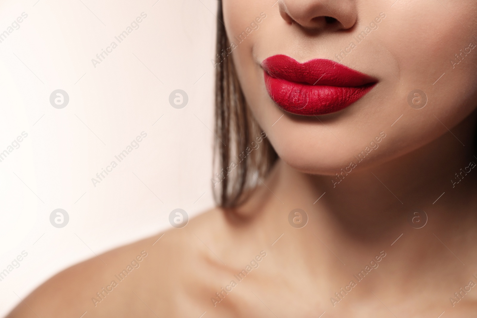 Photo of Woman with red lipstick on light background, closeup