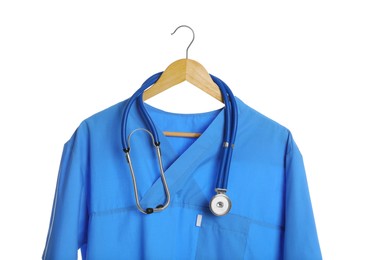 Photo of Light blue medical uniform and stethoscope on white background